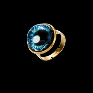 Close-up of a golden adjustable ring base with a blue evil eye glass cabochon inlay