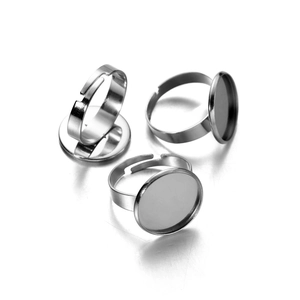 Macro detail of adjustable stainless steel ring bases with flat round trays for DIY jewelry