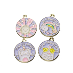Detailed macro view of colorful enamel fruit and pet pendants with positive quotes