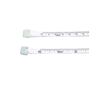 Detail of soft measuring tape showing dual scales in 150cm metric and 60 inch imperial units