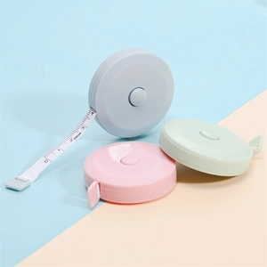 Close-up of colorful 150cm retractable tape measures in pastel pink, blue, and green colors