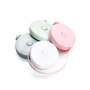 Macro view of compact round colorful retractable measuring tape with 150cm scale markings