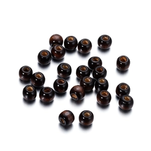 Detailed view of polished dark brown maple wood beads with smooth grain for DIY jewelry