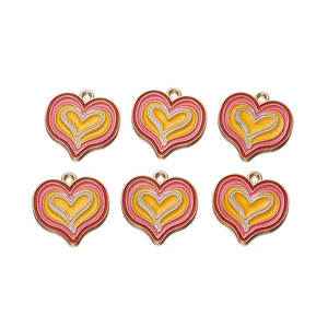 Detailed view of six heart-shaped enamel alloy pendants for DIY jewelry making