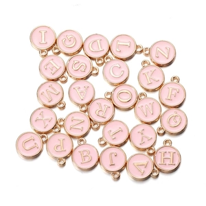 Detail of pink enamel round letter charms with gold plating for DIY jewelry making