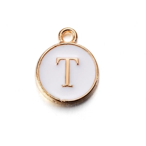 Macro detail of alloy letter T pendant with white enamel inlay for DIY jewelry projects