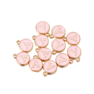 Macro shot of light pink enamel alphabet charms with golden letter A and loop