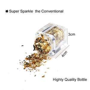 Detailed view of super sparkle gold foil flakes pouring from a clear 3g jar for nail art decor