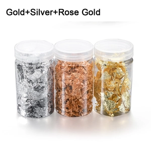 Detailed view of gold, silver, and rose gold foil flakes in clear plastic jars for nail art