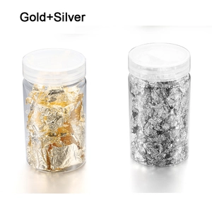 Detail of gold and silver foil flakes in transparent jars for nail art and DIY crafts