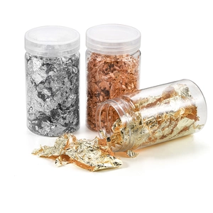 Metallic gold and silver foil flakes set in clear jars for nail art and DIY crafts decoration
