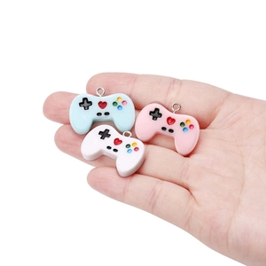 Detailed view of colorful resin game controller charms for DIY jewelry and keychains