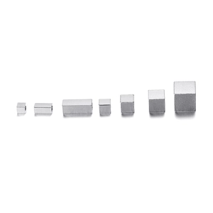 Macro detail of various sizes of polished stainless steel square spacer beads for DIY jewelry