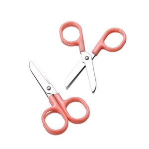 Close-up of two pink safety scissors with rounded tips for children and sewing crafts