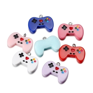 Macro view of colorful resin mini game controller charms with silver metal rings for DIY crafts