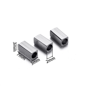 Detailed macro view of 7mm brushed stainless steel square spacer beads with 2mm center hole