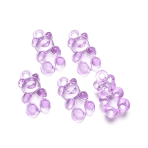Close-up of translucent light purple resin bear pendants with top rings for DIY crafts