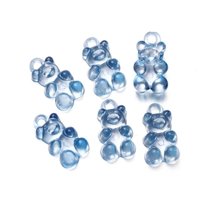 Detailed view of six translucent blue resin bear pendants for DIY jewelry crafts
