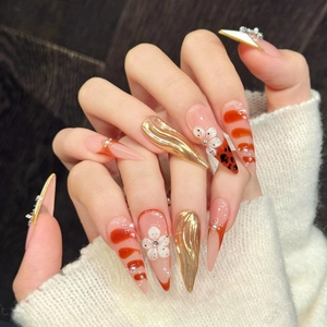 Handmade long almond press-on nails with 3D gold wave, floral accents and marble texture