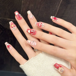 Pink and white handmade press-on nails with 3D hearts, pearls and stars in coffin shape