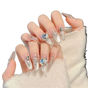 Glossy grey cat-eye almond press-on nails with silver glitter and large crystal accents