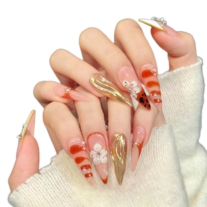 French stiletto press-on nails with golden relief, leopard spots, and white 3D flowers