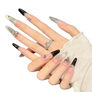 Elegant purple cat-eye press-on nails with black French tips and crystal 3D bow accents
