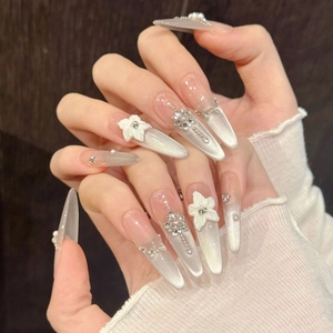 Cat eye press-on nails with 3D white flowers, snowflakes, and pearls decoration