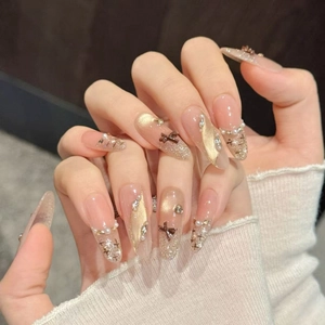Brown bow press-on nails with champagne cat eye glitter and pearl accents