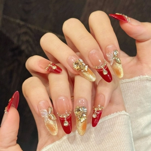 Handmade press-on nails with red cat eye effect and 3D butterfly gold accents