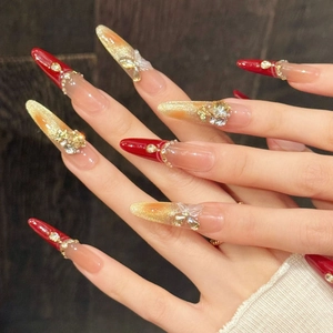 Handmade red cat eye press-on nails with 3D butterfly, rhinestones, and gold glitter