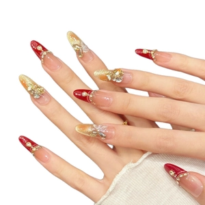 Handmade almond press-on nails featuring red French tips, gold glitter, and 3D butterflies