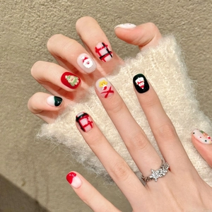 Handmade Christmas press-on nails featuring Santa, snowmen, and festive red plaid patterns
