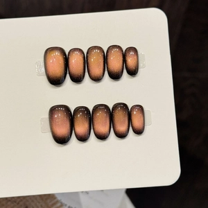 Handmade brown gradient cat-eye press-on nails in oval shape with shimmering metallic finish