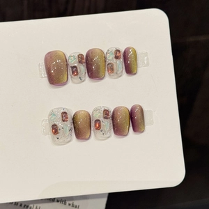 Handmade brown and gold cat-eye press-on nails with glitter and star rhinestones