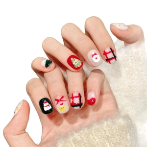Handmade Christmas bear press-on nails with festive reindeer, tree and plaid designs
