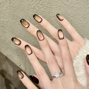 Handmade brown gradient cat-eye press-on nails in long oval shape with star ring