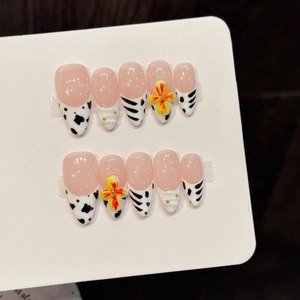 Handmade press-on nails with pink floral accents, cow print, and 3D floral textures