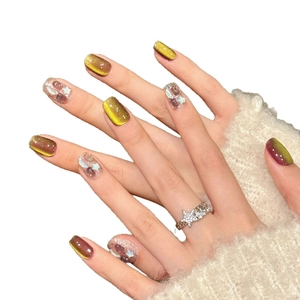 Brown cat eye press-on nails with golden gradient, purple stones and star glitter