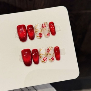 Handmade red cat eye press-on nails with elegant gold leaf and flower floral designs