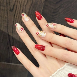 Elegant red cat eye press-on nails with handmade floral art and gold leaf accents