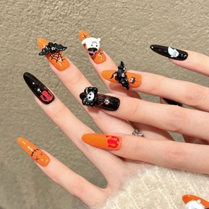 Halloween press-on nails featuring 3D bats, ghosts, and spider webs on orange and black tips