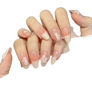Handmade almond press-on nails with pink gradient, relief flowers and pearls