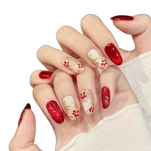 Handmade red and gold flower press-on nails with cat-eye effect and floral patterns