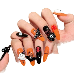 Halloween press-on nails with 3D ghost and skull charms in orange and black gloss