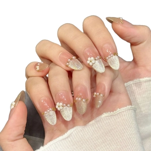 Pink pearl press-on nails with champagne gold cat eye glitter and 3D floral accents