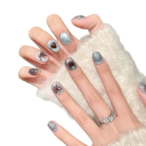 Blue-brown bow press-on nails featuring 3D hearts, stars, and grey cat eye finish