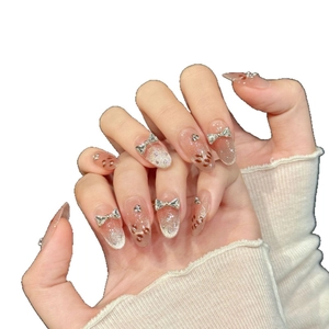Pink gradient cat eye press-on nails with silver diamond bow and heart accents