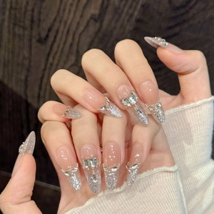 Handmade almond press-on nails with silver glitter gradient and rhinestones