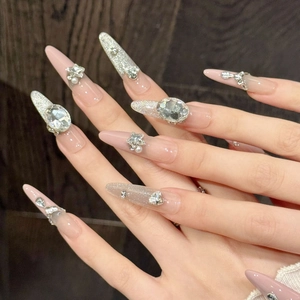 Handmade luxury long stiletto press-on nails with pink glitter and sparkling rhinestones